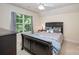 Comfortable bedroom with a queen-size bed, bedside table, and a large window at 2804 Pulaski Dr, Monroe, NC 28110