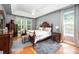 Spacious bedroom featuring hardwood floors, a tray ceiling, and a large window at 2804 Pulaski Dr, Monroe, NC 28110