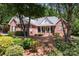 Attractive brick home featuring a covered front porch and well-maintained landscaping with mature trees at 2804 Pulaski Dr, Monroe, NC 28110