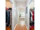 Hallway with closets leading to a bathroom with a soaking tub at 2804 Pulaski Dr, Monroe, NC 28110