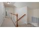 Carpeted hallway with wood railing leading to another room at 2804 Pulaski Dr, Monroe, NC 28110