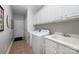 Functional laundry room with washer, dryer, sink, and plenty of storage at 2804 Pulaski Dr, Monroe, NC 28110