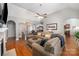Spacious living room with hardwood floors, fireplace, and open layout leading to the dining and kitchen areas at 2804 Pulaski Dr, Monroe, NC 28110