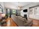 Bright living room features hardwood floors, a fireplace, built-in bookshelves, and large windows at 2804 Pulaski Dr, Monroe, NC 28110