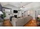 Open living room boasts hardwood floors, built-in bookshelves, a fireplace, and a vaulted ceiling at 2804 Pulaski Dr, Monroe, NC 28110