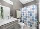 Bathroom with neutral walls, gray vanity, and a patterned shower curtain at 3615 Alamito Ln, Charlotte, NC 28214