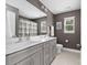 Bathroom featuring gray walls, double sinks, a large mirror and tiled floor at 3615 Alamito Ln, Charlotte, NC 28214