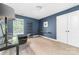 Bedroom with blue walls, carpet, a desk, and a window with natural light at 3615 Alamito Ln, Charlotte, NC 28214