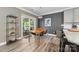 Dining area featuring modern furniture, natural light, and access to an outdoor space at 3615 Alamito Ln, Charlotte, NC 28214