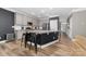 Modern kitchen with stainless appliances, granite countertops, island with bar stool seating, and wood floors at 3615 Alamito Ln, Charlotte, NC 28214