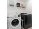 Laundry room showcasing a front-load washer, dryer, and storage shelves for supplies at 3615 Alamito Ln, Charlotte, NC 28214