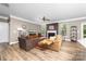 Relaxing living room featuring a fireplace, comfortable seating, and wood laminate flooring at 3615 Alamito Ln, Charlotte, NC 28214