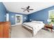 Spacious main bedroom with blue walls, neutral carpet, ceiling fan, and modern fixtures at 3615 Alamito Ln, Charlotte, NC 28214