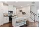 Open kitchen features a center island, stainless steel appliances, and bar stool seating at 4209 Summit Woods Dr, Charlotte, NC 28216