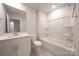 Clean bathroom featuring a tub/shower combo, white fixtures, and ample lighting, perfect for relaxation at 4213 Summit Woods Dr, Charlotte, NC 28216