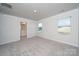 Bright and spacious bedroom with neutral carpet, large windows, and an ensuite bathroom at 4213 Summit Woods Dr, Charlotte, NC 28216