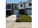 Charming townhouse with a well-manicured lawn and a 'move-in ready' sign at 4213 Summit Woods Dr, Charlotte, NC 28216