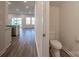 Modern powder room featuring a white toilet and neutral wall paint, conveniently located near the home's living area at 4213 Summit Woods Dr, Charlotte, NC 28216