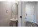 Stylish powder room featuring a pedestal sink, an oval mirror, and a convenient location near the entryway at 4213 Summit Woods Dr, Charlotte, NC 28216