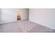 Empty bedroom featuring fresh carpet, a walk-in closet, and potential for a personalized and cozy atmosphere at 4217 Summit Woods Dr, Charlotte, NC 28216