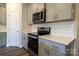 Well-equipped kitchen with stainless steel appliances, gray cabinets, and ample counter space for culinary enthusiasts at 4217 Summit Woods Dr, Charlotte, NC 28216