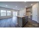 Modern kitchen with gray cabinets, stainless steel appliances, and a functional island for food preparation and dining at 4217 Summit Woods Dr, Charlotte, NC 28216