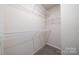 Walk-in closet featuring wire shelving for optimal storage, and neutral carpeting at 4221 Summit Woods Dr, Charlotte, NC 28216
