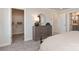 Bedroom with gray carpet, large dresser, and walk in closet at 4229 Summit Woods Dr, Charlotte, NC 28216