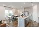 Open concept kitchen and living area with lots of natural light, a kitchen island, and an adjacent dining area at 4229 Summit Woods Dr, Charlotte, NC 28216