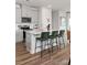 Kitchen with island, stainless steel appliances, white cabinets, and hardwood floors at 4229 Summit Woods Dr, Charlotte, NC 28216