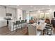 Open concept living room and kitchen with white cabinets, kitchen island, and plenty of natural light at 4229 Summit Woods Dr, Charlotte, NC 28216