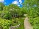 An aerial view shows a home with mature trees and manicured landscaping at 4523 Fox Brook Ln, Charlotte, NC 28211