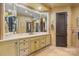 Well-lit bathroom features a large mirror, marble countertops, and custom cabinetry at 4523 Fox Brook Ln, Charlotte, NC 28211