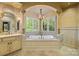 Inviting bathroom features a soaking tub, large windows, and elegant fixtures at 4523 Fox Brook Ln, Charlotte, NC 28211