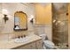Well-appointed bathroom with tiled shower, custom vanity, and decorative lighting fixtures at 4523 Fox Brook Ln, Charlotte, NC 28211
