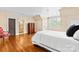 Comfortable bedroom featuring hardwood floors, a large window, and a cozy chair at 4523 Fox Brook Ln, Charlotte, NC 28211