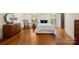 Bright bedroom with hardwood floors, neutral walls, and large windows with charming window treatments at 4523 Fox Brook Ln, Charlotte, NC 28211