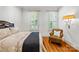 Serene bedroom with hardwood floors, natural light and a chair to relax in at 4523 Fox Brook Ln, Charlotte, NC 28211