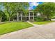 Stately home with a large front yard, mature trees, and a circular driveway at 4523 Fox Brook Ln, Charlotte, NC 28211