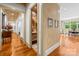 Hallway with hardwood floors leads to the dining room and a conveniently-located half bathroom at 4523 Fox Brook Ln, Charlotte, NC 28211