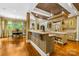 Custom kitchen with a center island, breakfast area and warm, decorative finishes at 4523 Fox Brook Ln, Charlotte, NC 28211