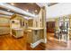 Open kitchen layout with center island, counter seating and wood floors at 4523 Fox Brook Ln, Charlotte, NC 28211
