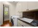 This laundry room features a sink, storage, and a side-by-side washer and dryer at 4523 Fox Brook Ln, Charlotte, NC 28211