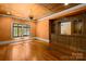 Cozy living room with hardwood floors, custom built-in cabinets, and ample natural light at 4523 Fox Brook Ln, Charlotte, NC 28211