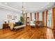 Bright main bedroom features hardwood floors, large windows, and ample natural light at 4523 Fox Brook Ln, Charlotte, NC 28211