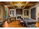 Home office features a fireplace, custom built-ins, and hardwood floors at 4523 Fox Brook Ln, Charlotte, NC 28211