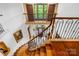 Elegant staircase featuring ornate iron railings and a patterned runner leading to the upper level at 4523 Fox Brook Ln, Charlotte, NC 28211