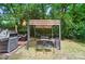 The backyard features a pergola with lighting, seating, and a barbeque grill at 4647 General Pershing Dr, Charlotte, NC 28209