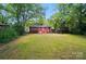 Expansive backyard surrounded by mature trees, offering a private and serene outdoor space at 4647 General Pershing Dr, Charlotte, NC 28209