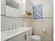 Bright bathroom featuring white tile, vanity, and patterned window shade at 4647 General Pershing Dr, Charlotte, NC 28209